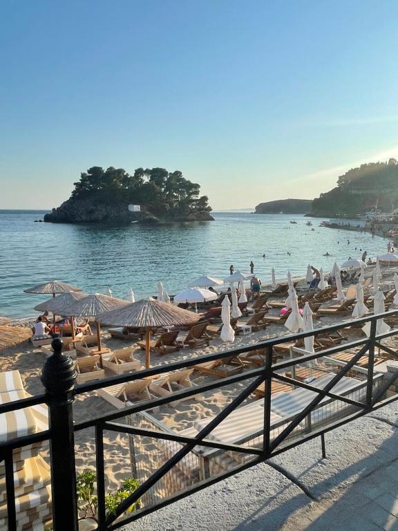 a beach with chairs and umbrellas and the ocean at Pargas paradise in Parga