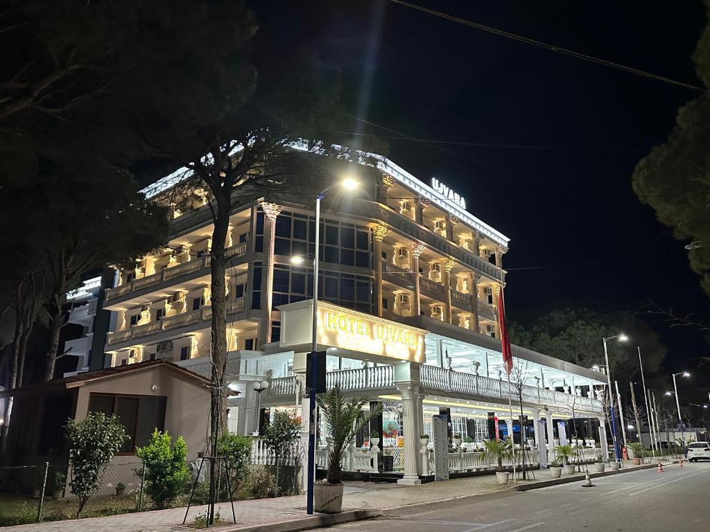 a large building with a hotel sign in front of it at Ujvara Hotel in Golem