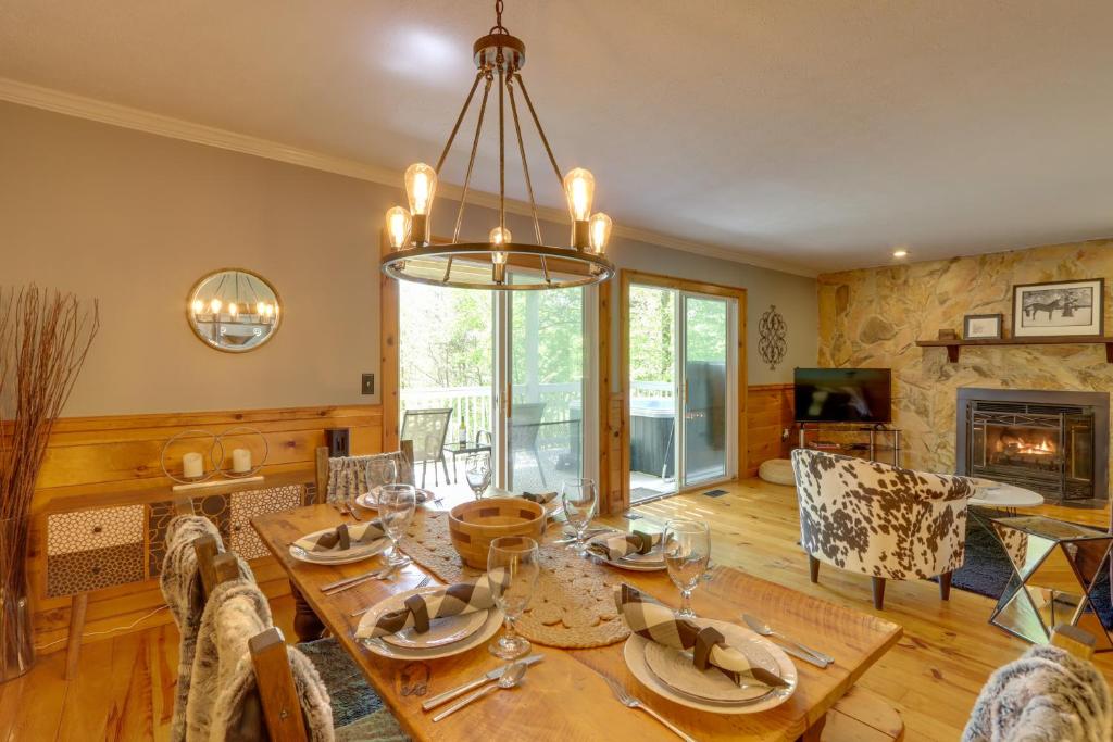a dining room with a table and a chandelier at Blue Ridge Getaway with Hot Tub and Seasonal View! in Blue Ridge