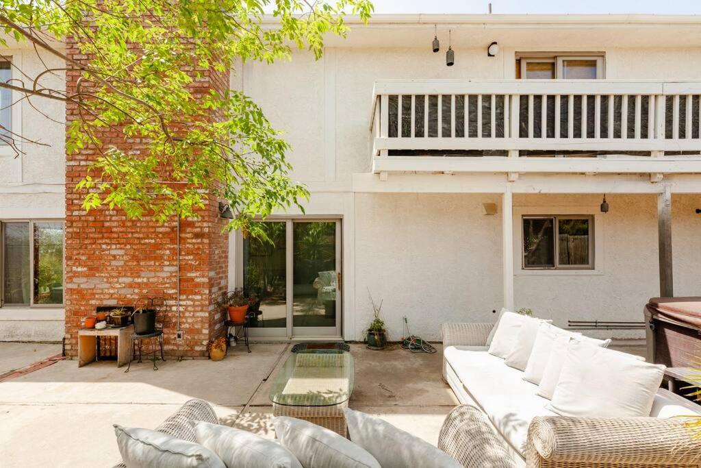 a living room with a white couch in front of a building at Malibu Seaside Bliss with Hot Tub and Beach & Hike nearby in Malibu