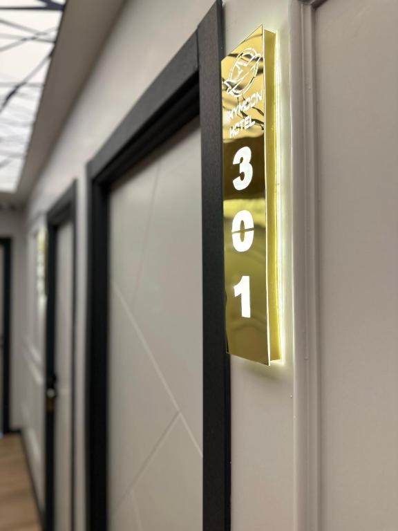 a door sign with the number three on it at Skymoon Istanbul Airport Hotel in Arnavutköy