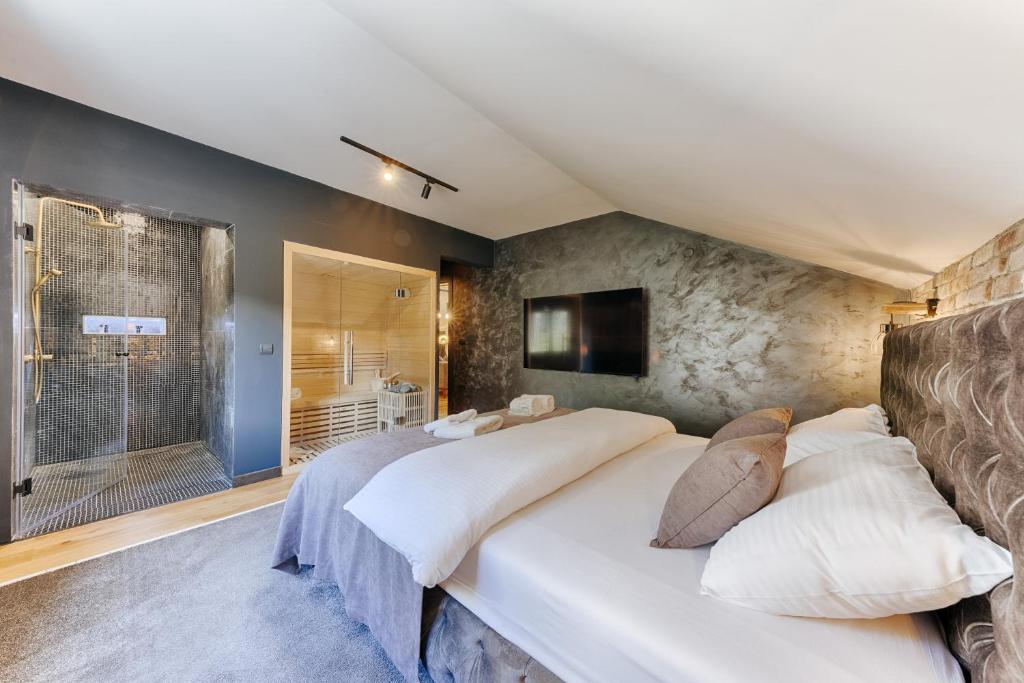 a bedroom with a large bed and a tv at La Vida Apartments in Bar