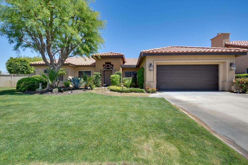 a house with a driveway and a garage at Bella Vista La Quinta Home with Pool and Spa! in La Quinta