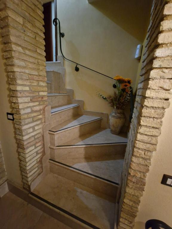 a staircase in a house with a vase of flowers at Al corso 3 in Naro