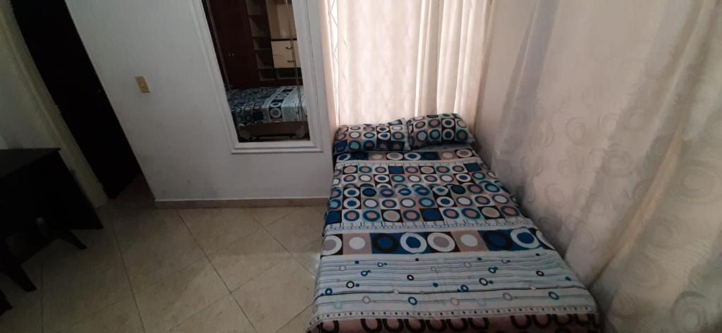 a row of chairs in a room with a mirror at Casa Hostal Aromas. Habitación acomodacion multiple in Bucaramanga