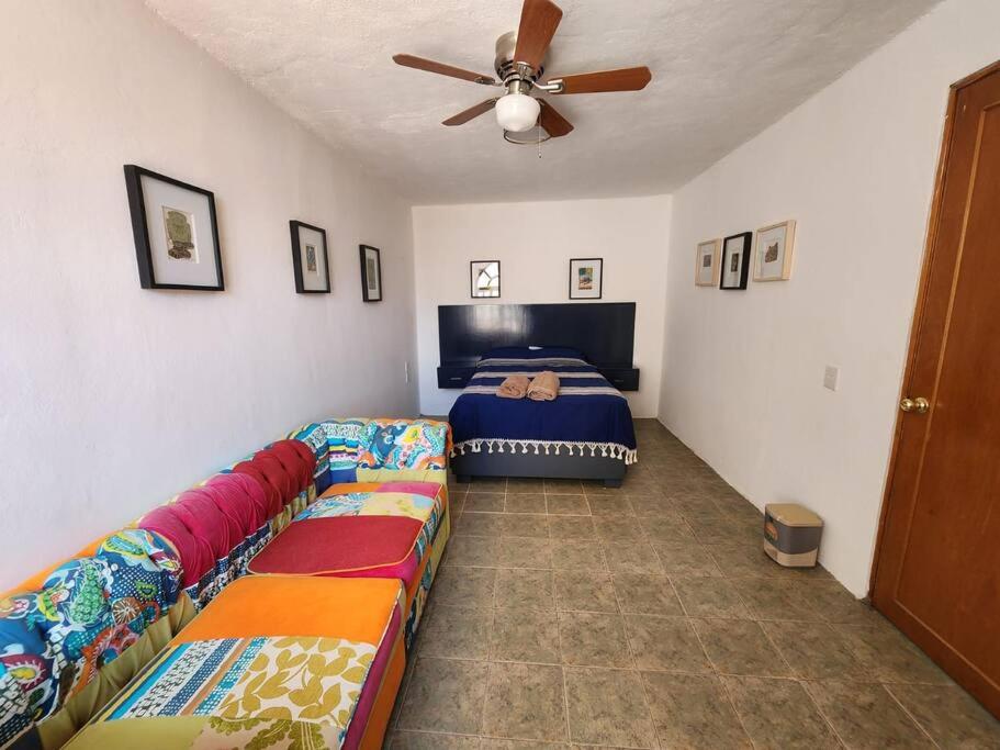 a bedroom with a bed and a ceiling fan at Casa Orestes - Hermosa casa cerca del Centro de Oaxaca in Oaxaca City