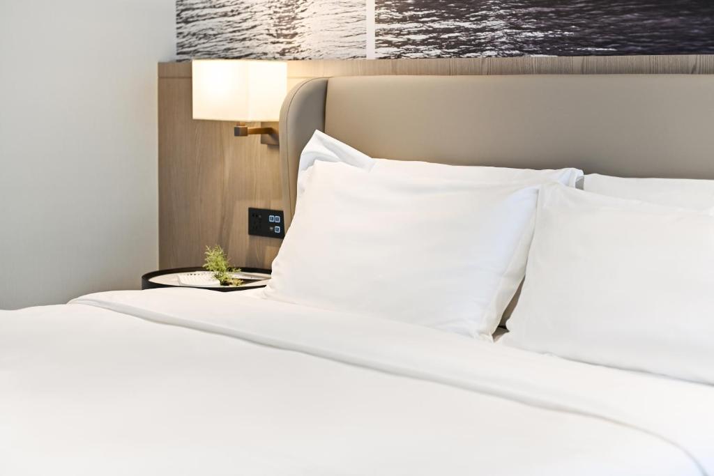 Postel nebo postele na pokoji v ubytování Livetour Hotel Luogang Science City Guangzhou