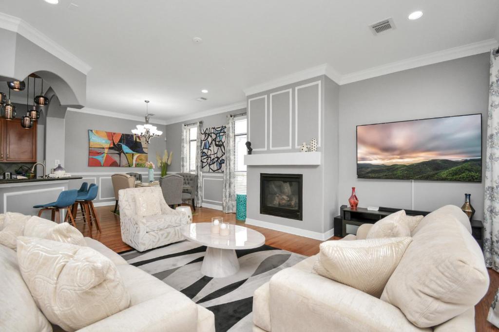 a living room with white furniture and a fireplace at 3BR 3Ba Upscale Luxury Home in The Heights in Houston