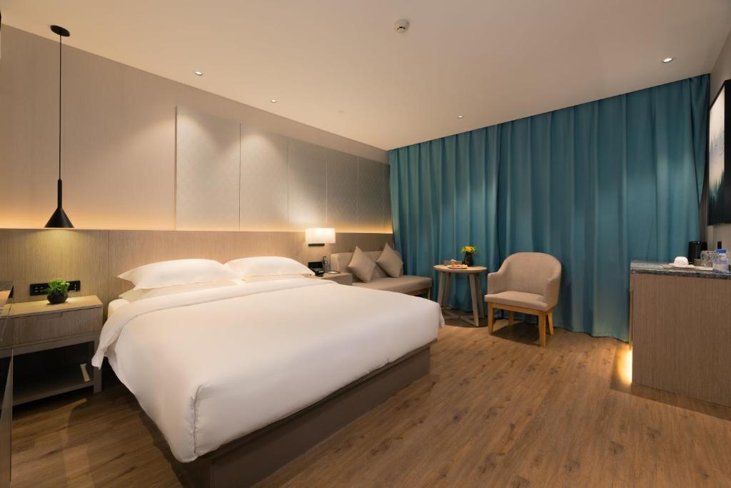 Postel nebo postele na pokoji v ubytování 义乌曼卡兰酒店国际商贸城店Yiwu kaiding Hotel