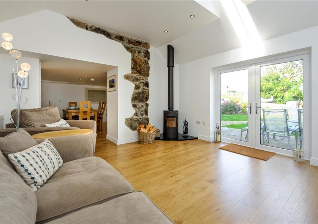 a living room with a couch and a fireplace at Jennys Cottage in Abersoch