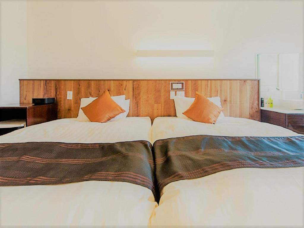 Postel nebo postele na pokoji v ubytování LiVEMAX RESORT Izu Shimoda