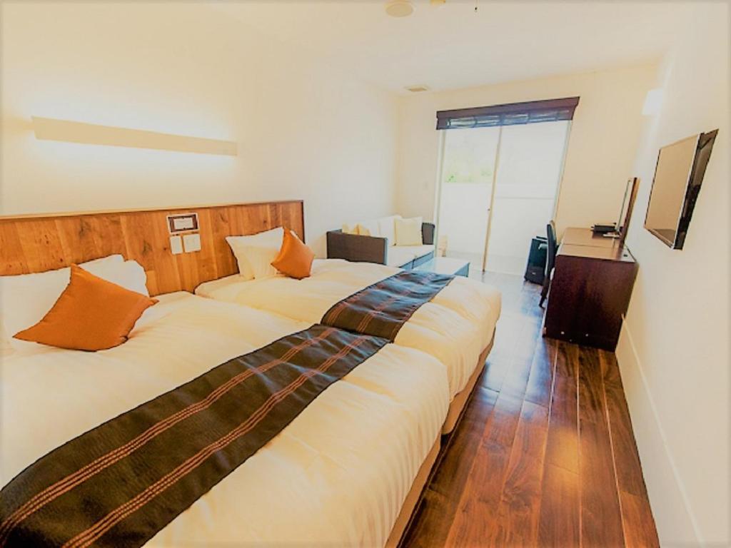 Postel nebo postele na pokoji v ubytování LiVEMAX RESORT Izu Shimoda