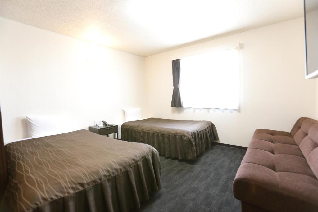 Postel nebo postele na pokoji v ubytování Osaka Corona Hotel
