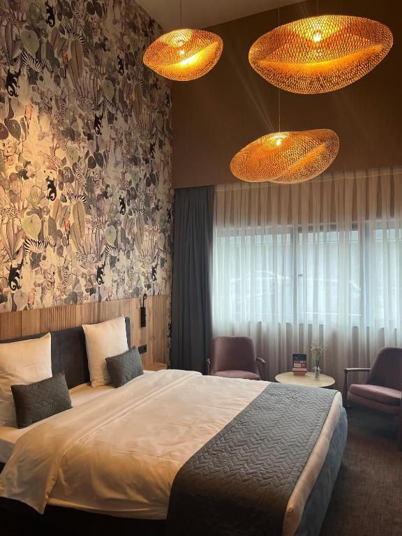 Postel nebo postele na pokoji v ubytování Hotel Le 830 Namur