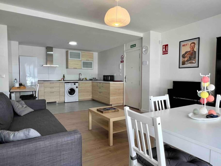 a living room and kitchen with a couch and a table at Apartamento Aguanaz 1 in Entrambasaguas