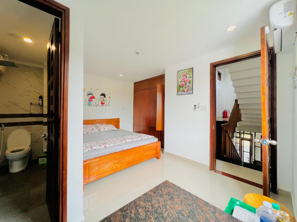 a bedroom with a bed and a bathroom at Kenpi Homestay in Hue