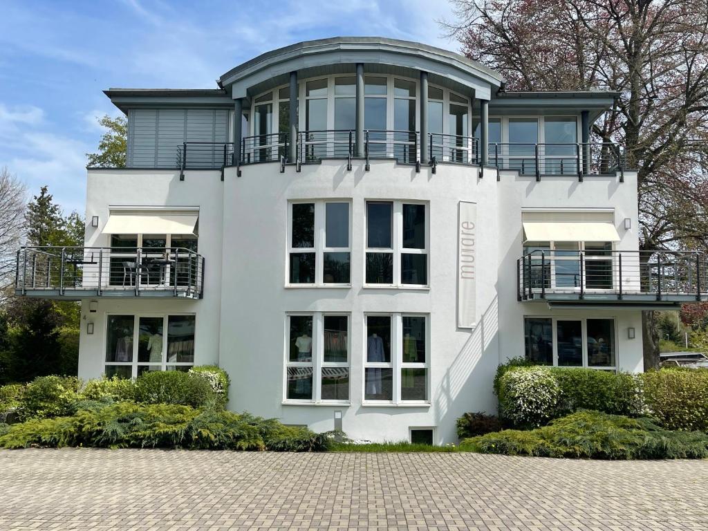 a large white house with a round turret at The Coffee Jacket Apartment in Chemnitz