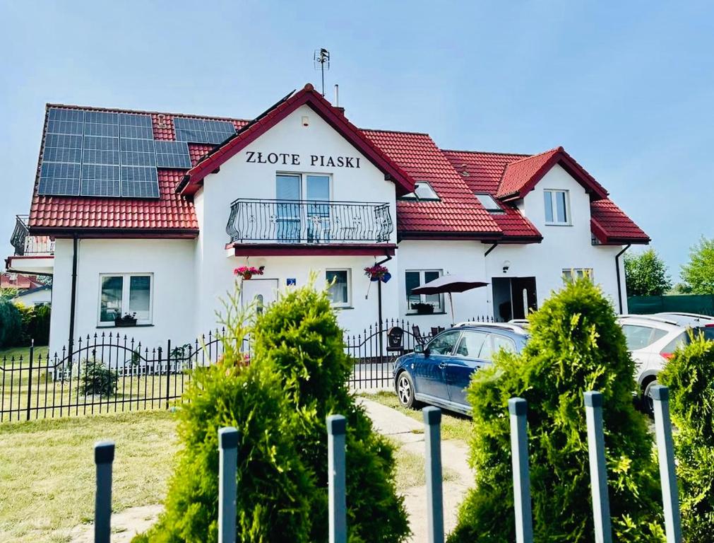 a house with solar panels on top of it at Złote Piaski in Darłowo