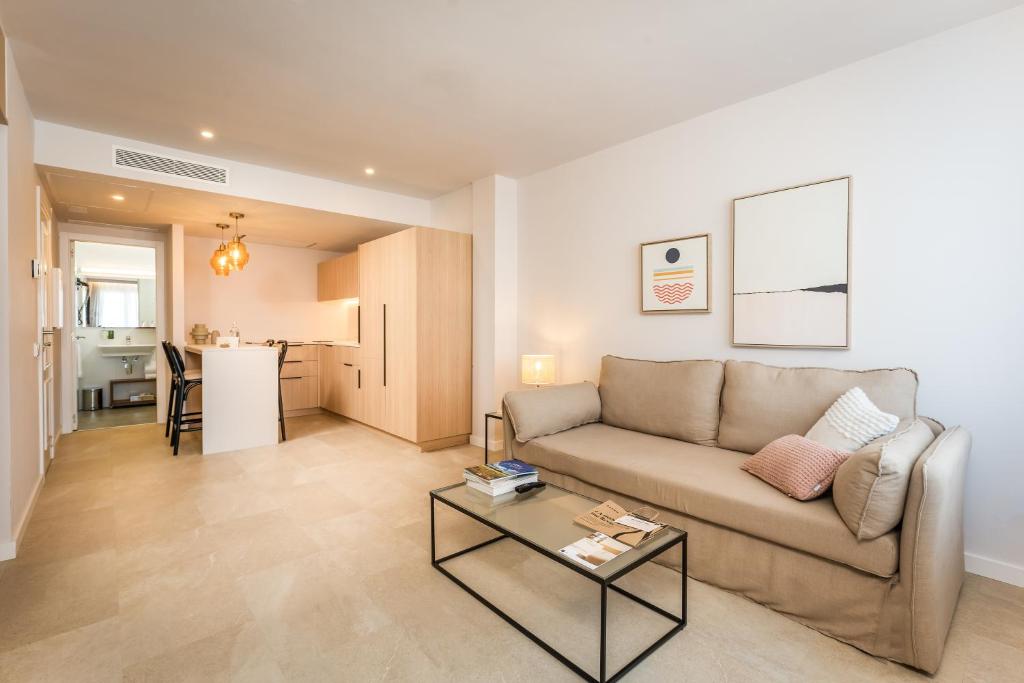 a living room with a couch and a table at ARTIEM Apartamentos in Mahón