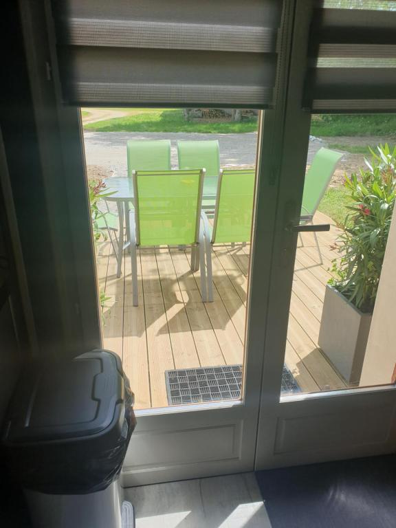 a view of a patio through a sliding glass door at LE REFUGE in Lurcy-Lévis