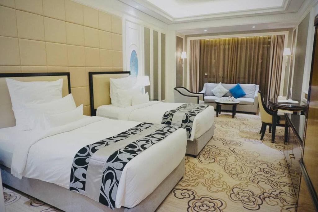 Posteľ alebo postele v izbe v ubytovaní LI HAO Hotel