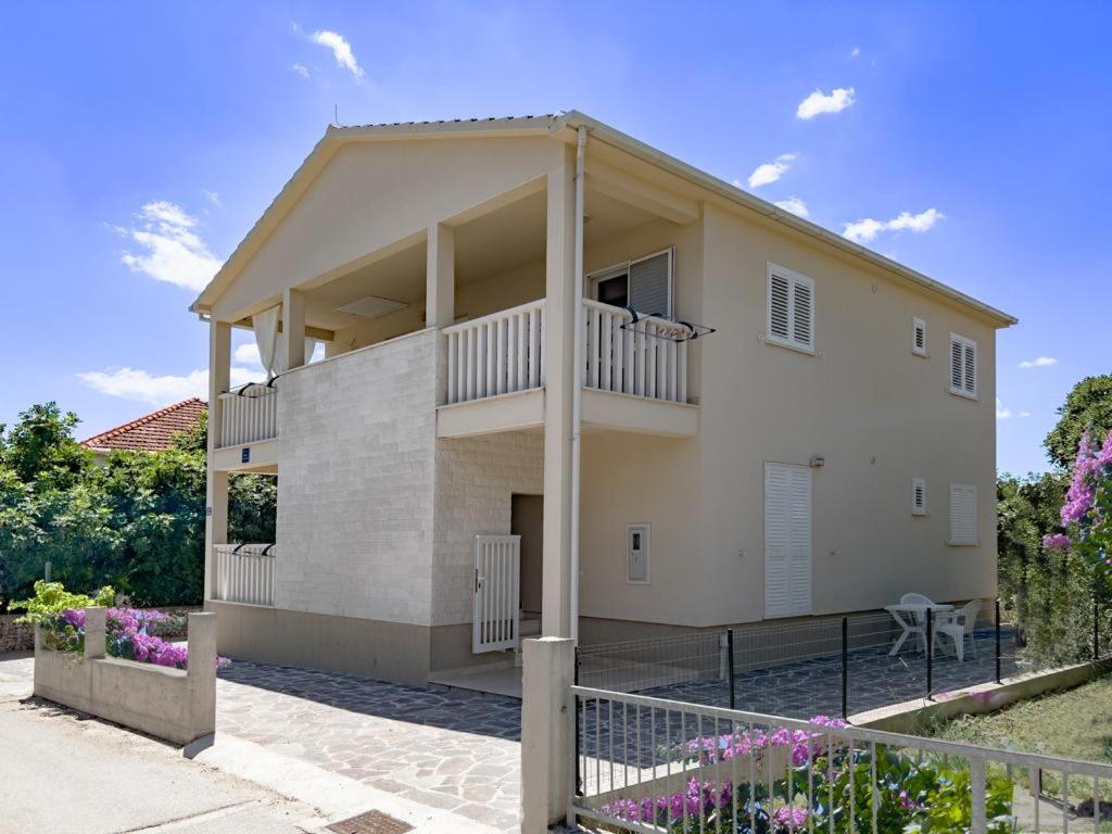 a large white house with a balcony at Apartments Juliet in Orebić