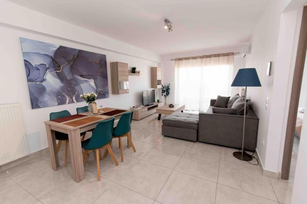 a living room with a table and chairs and a couch at Lovely 2-bedroom apartment with a city view (F10) in Piraeus