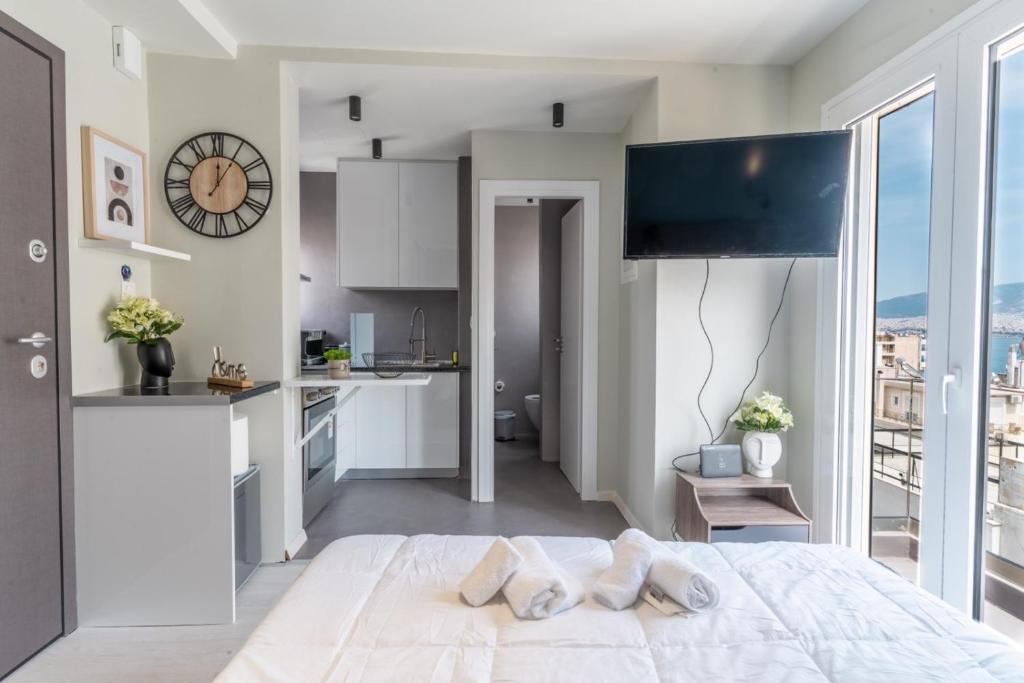 sypialnia z dużym łóżkiem i kuchnią w obiekcie Aiolos loft sea view peiraiki w Pireusie