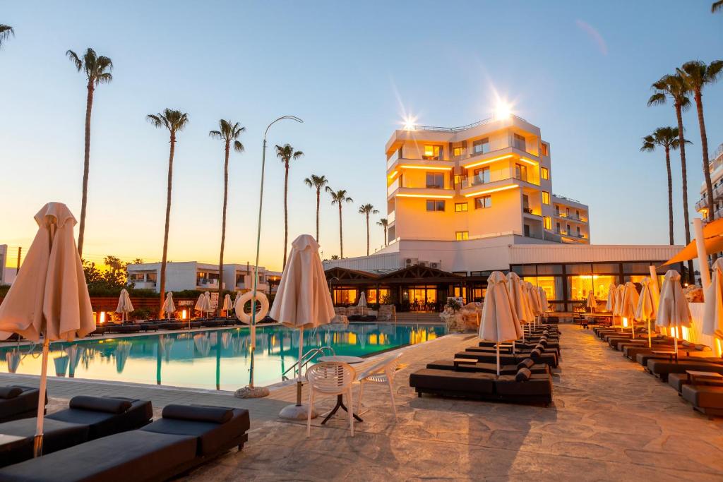 a hotel with a swimming pool and a building at Pavlo Napa Beach Hotel in Ayia Napa