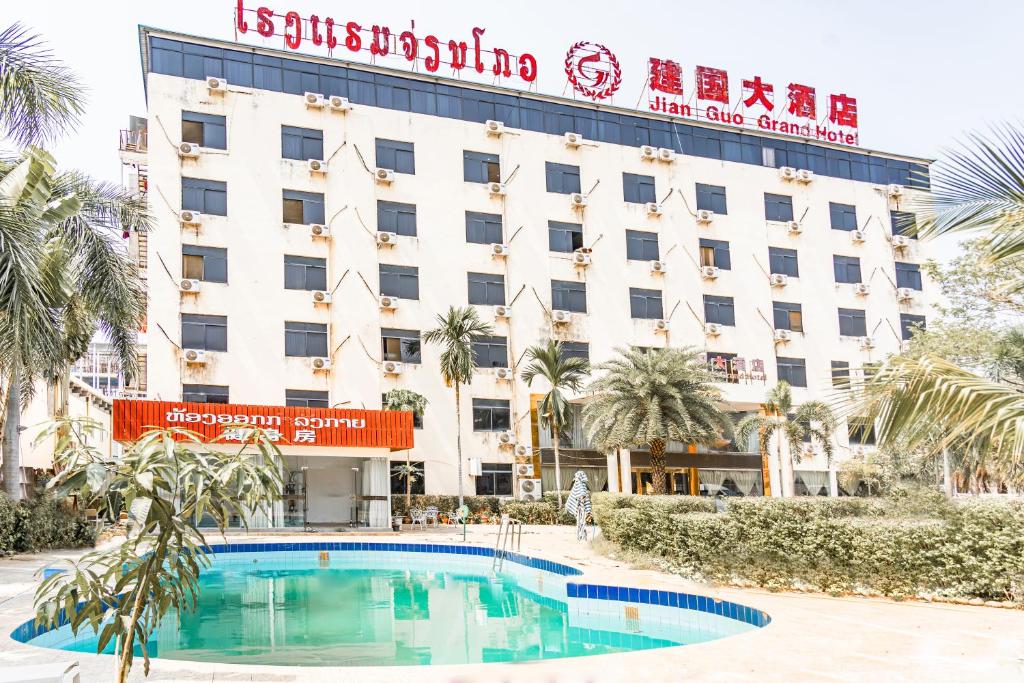 a hotel with a swimming pool in front of a building at 万象建国大酒店 