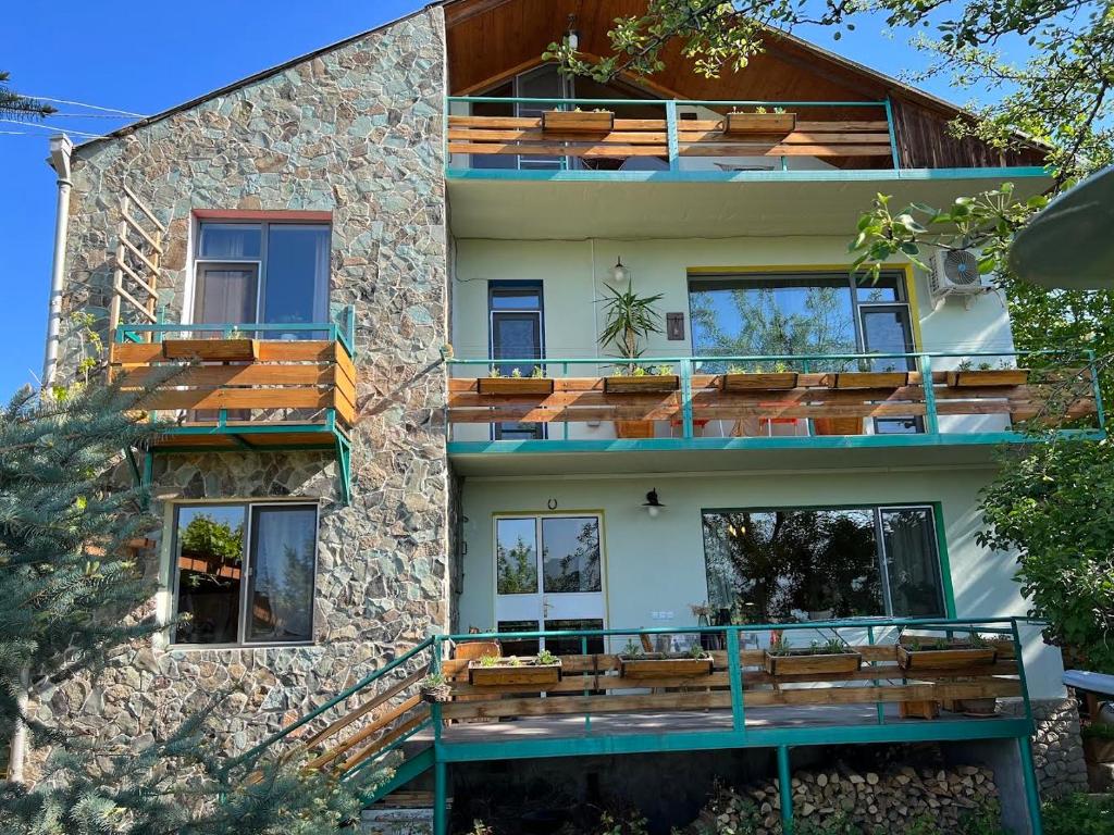 a house with wooden balconies on the side of it at Green Stone Boutique Hotel in Yeghegnadzor