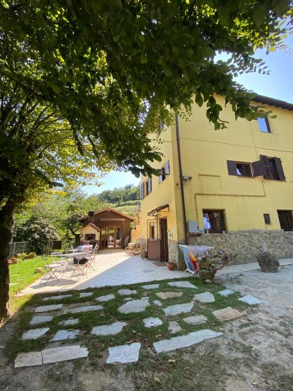 a building with a stone walkway in front of a building at Affittacamere Bocca d'Orso in Altare