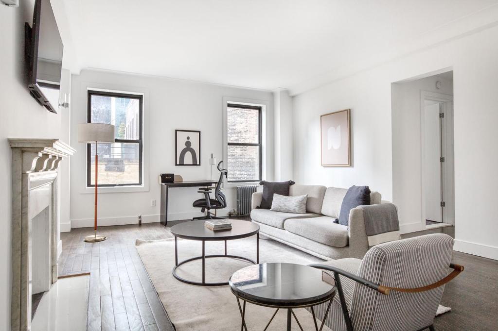 a living room with a couch and a table at Midtown 2br w doorman wd nr Central Park NYC-1144 in New York