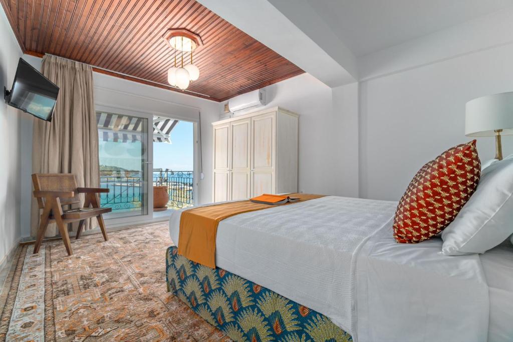 a hotel room with a bed and a balcony at Megaron Skiathos Boutique Residence in Skiathos Town