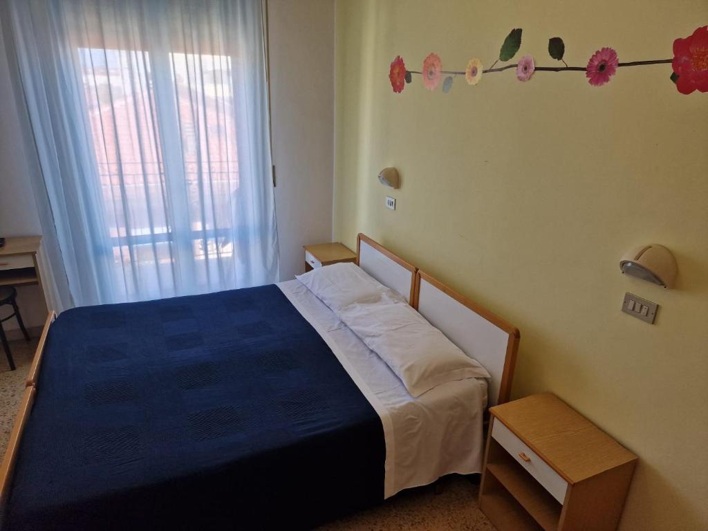 Postel nebo postele na pokoji v ubytování Hotel Clara RIMINI