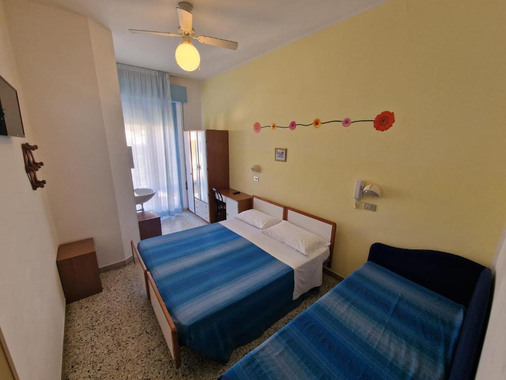 Postel nebo postele na pokoji v ubytování Hotel Clara RIMINI