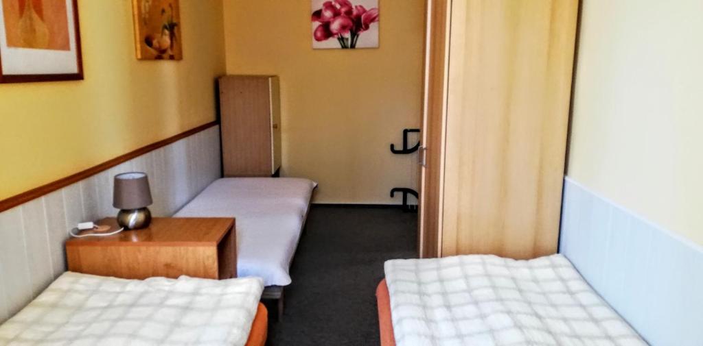 Postel nebo postele na pokoji v ubytování penzion U Soudu