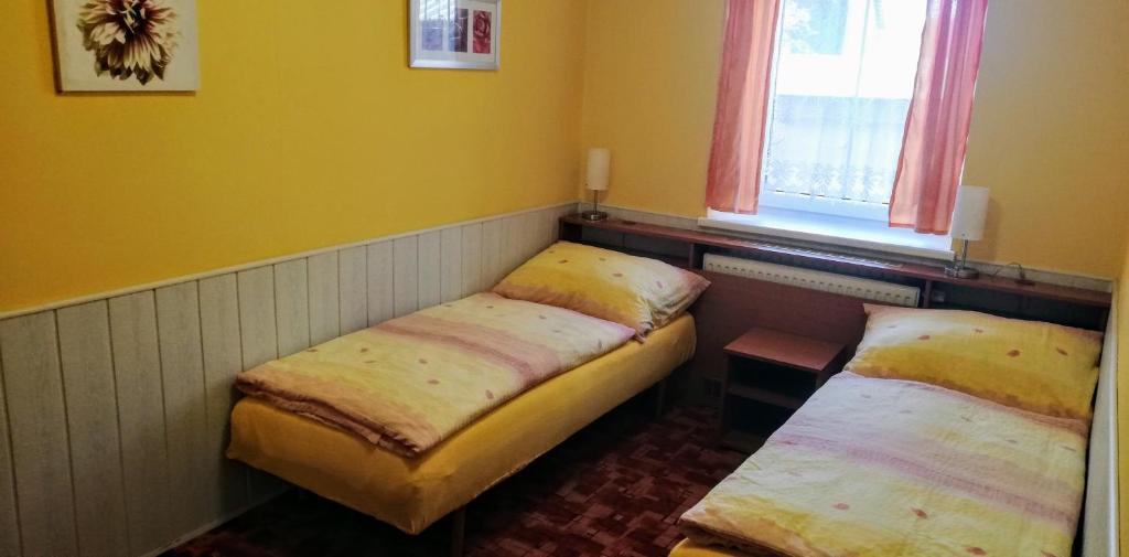 Postel nebo postele na pokoji v ubytování penzion U Soudu