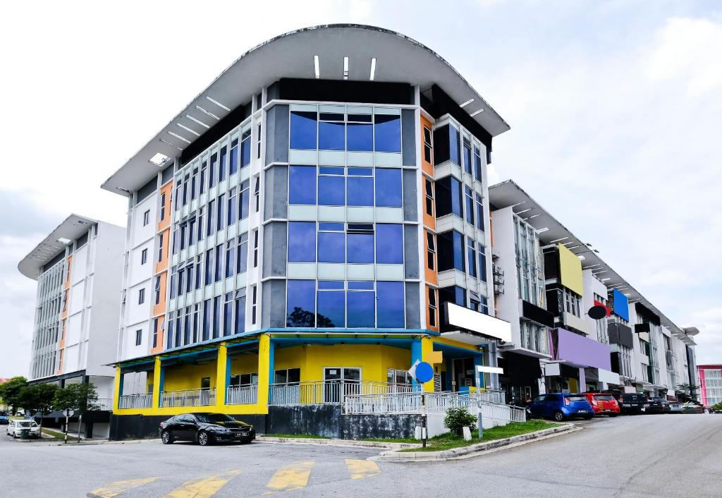 a building with a car parked in front of it at OYO 714 Arina Hotel in Bangi