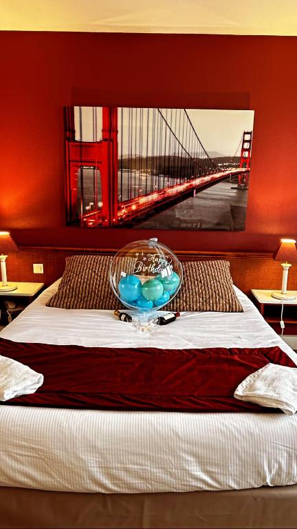 a bed with a bowl on it with a bridge at Hotel de l&#39;Europe in Dieppe