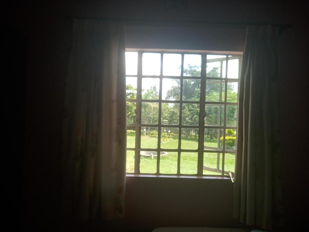 an open window with a view of a park at Key's Place in Ambira
