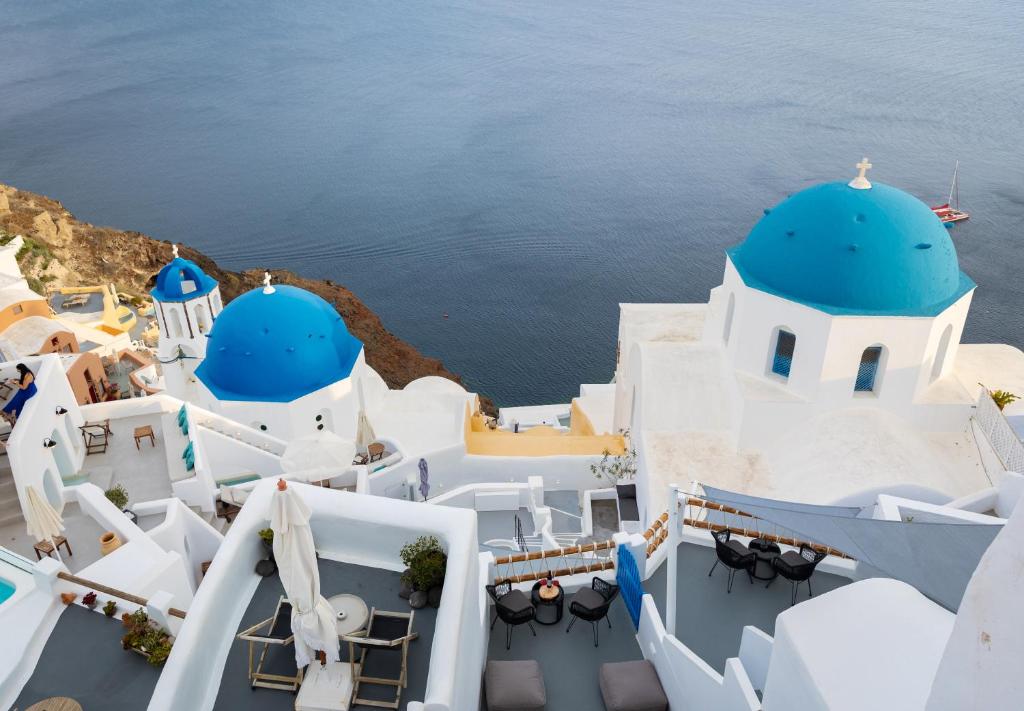 arial view of a building with blue domes at Luxus VIP Suites in Oia