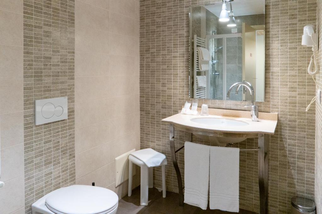 a bathroom with a sink and a toilet at Hotel Autoespresso Venice - Atika & Atif in Marghera