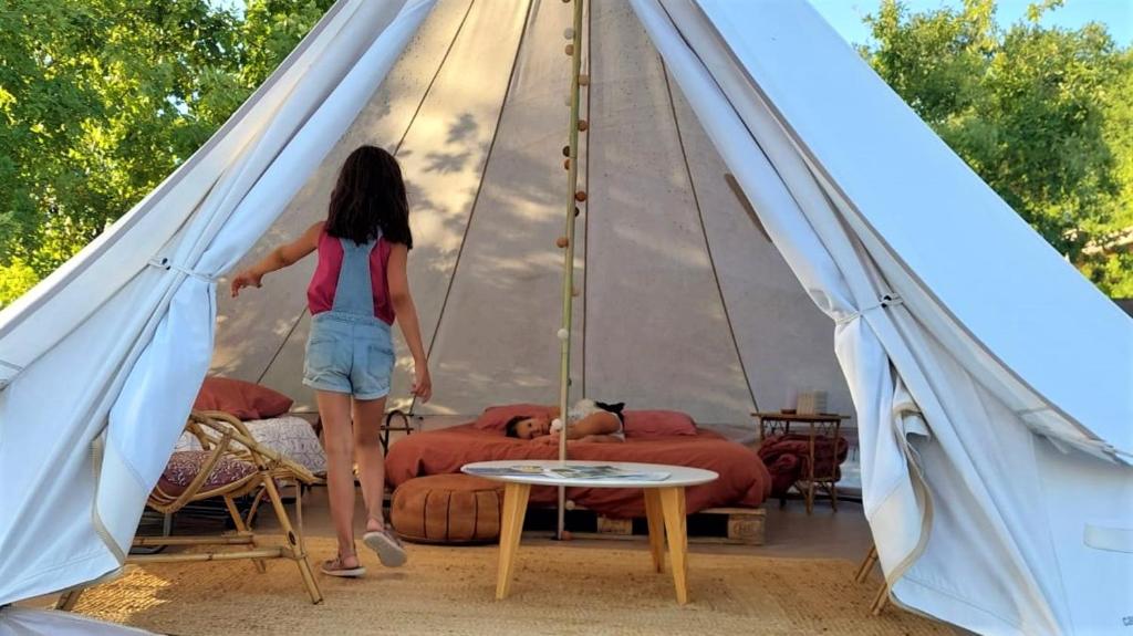 a woman is standing in a tent at Maison d hôtes Casa Sana in Pillac