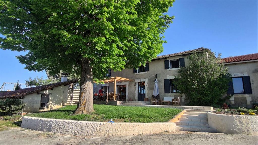a house with a tree in front of it at Maison d hôtes Casa Sana in Pillac