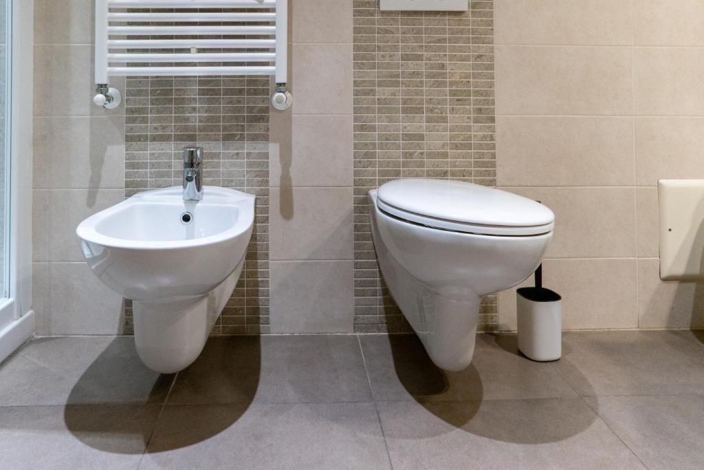 a bathroom with a toilet and a sink at Hotel Autoespresso Venice - Atika & Atif in Marghera