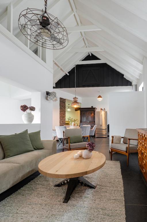 a living room with a couch and a table at Villa La Chatelaine in Egmond aan Zee