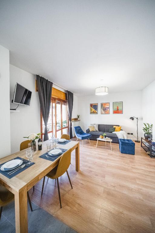 a living room with a table and a couch at Outdooredo Garda Apartment in Riva del Garda