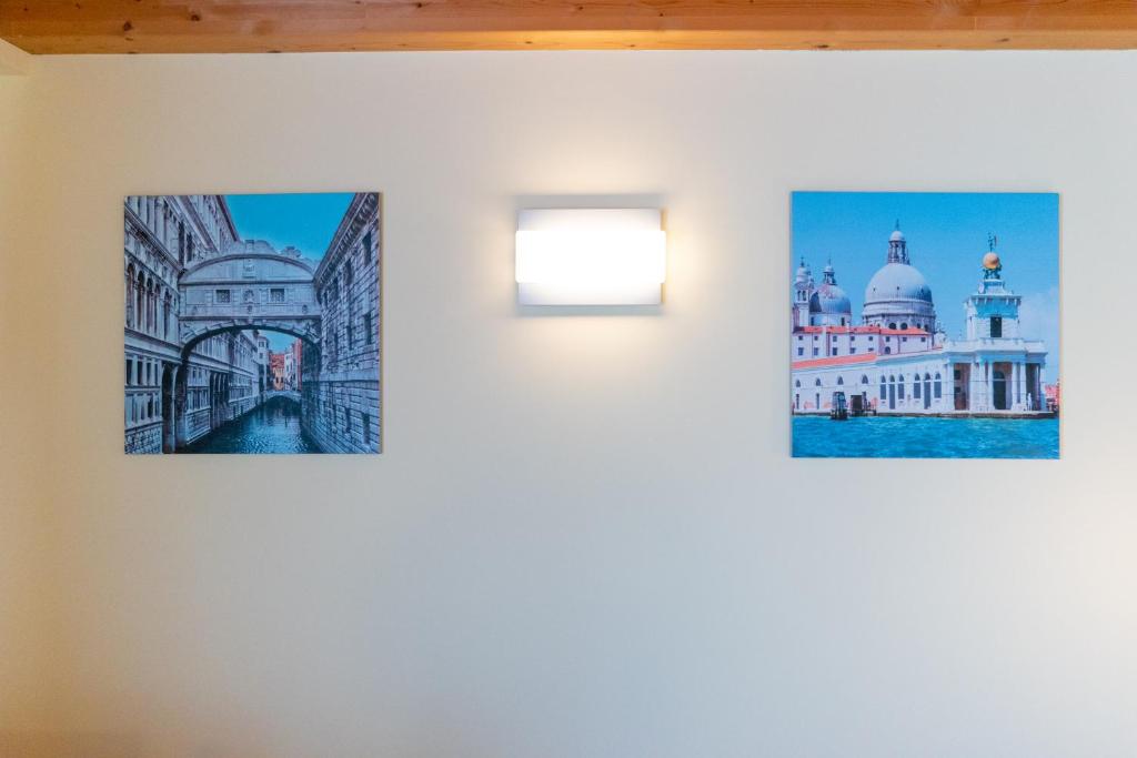 three photographs hanging on a wall in a room at Hotel Autoespresso Venice - Atika & Atif in Marghera