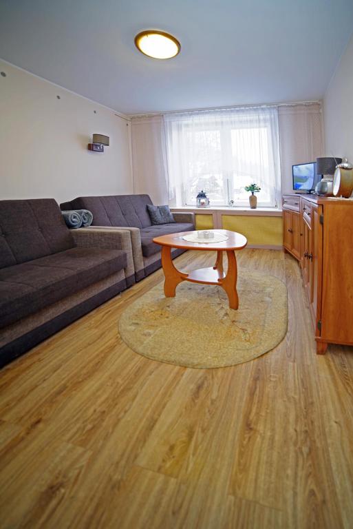 a living room with a table and a couch at Centrum Karkonoszy in Karpacz